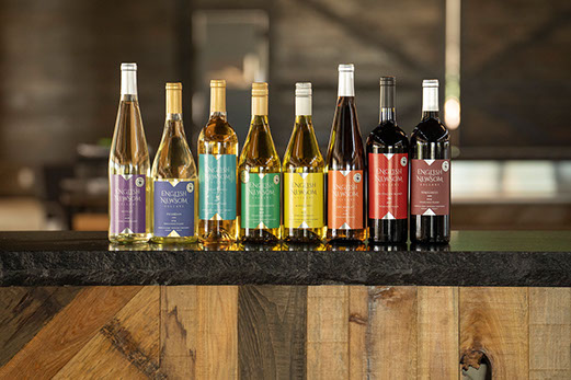 A line of English Newsom wine bottles on a counter top